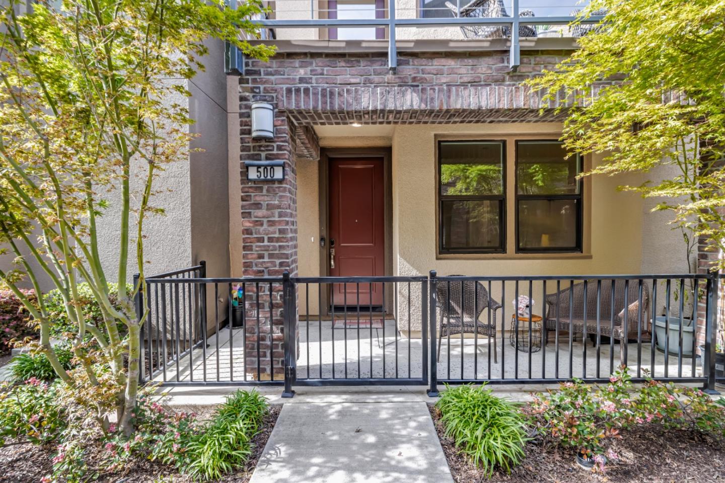 a front view of a house with a garden