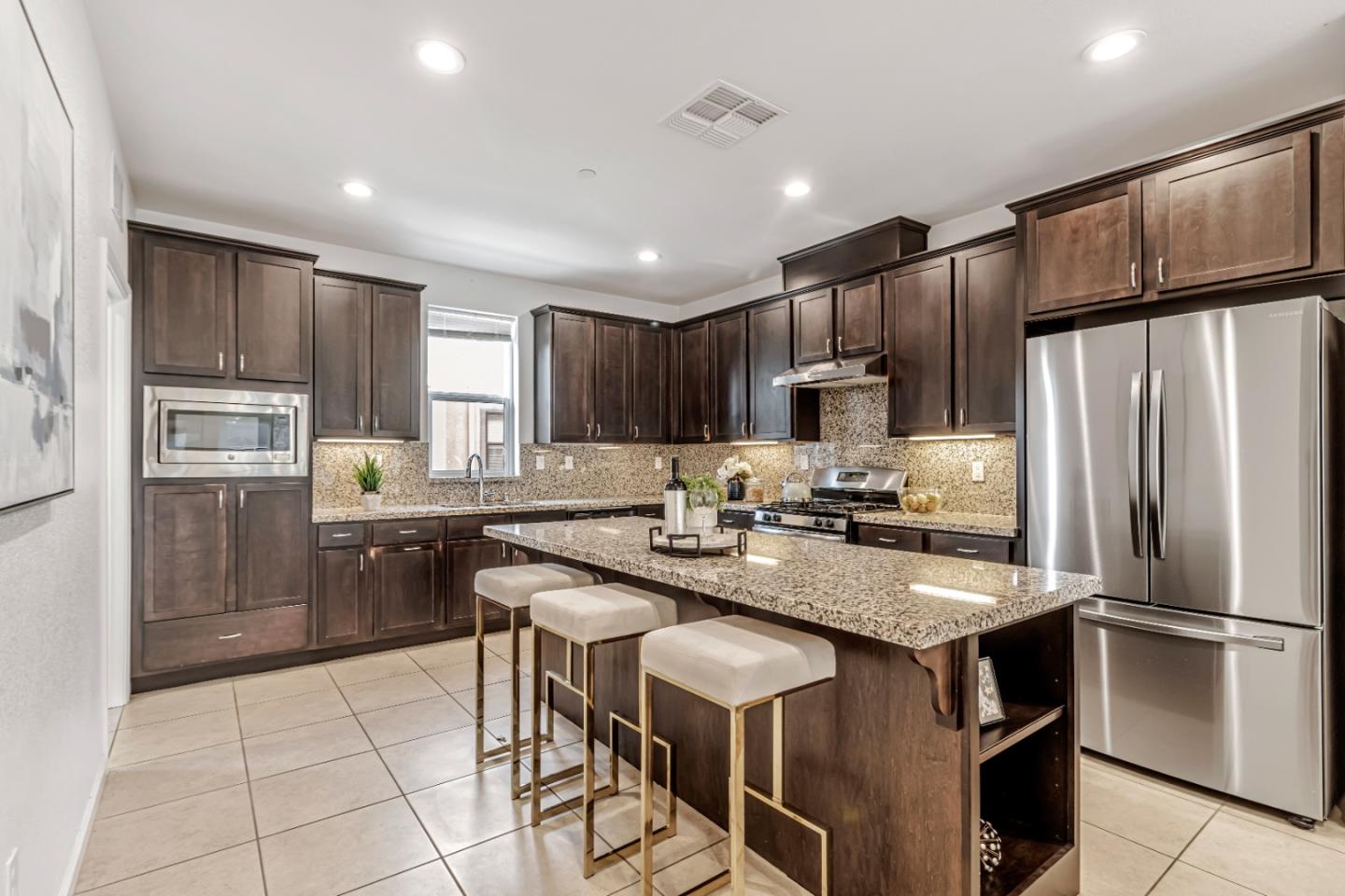 500 Lapin Place Hayward, CA 94541 - Photo 13 of 36 a kitchen with kitchen island a refrigerator stove microwave and cabinets