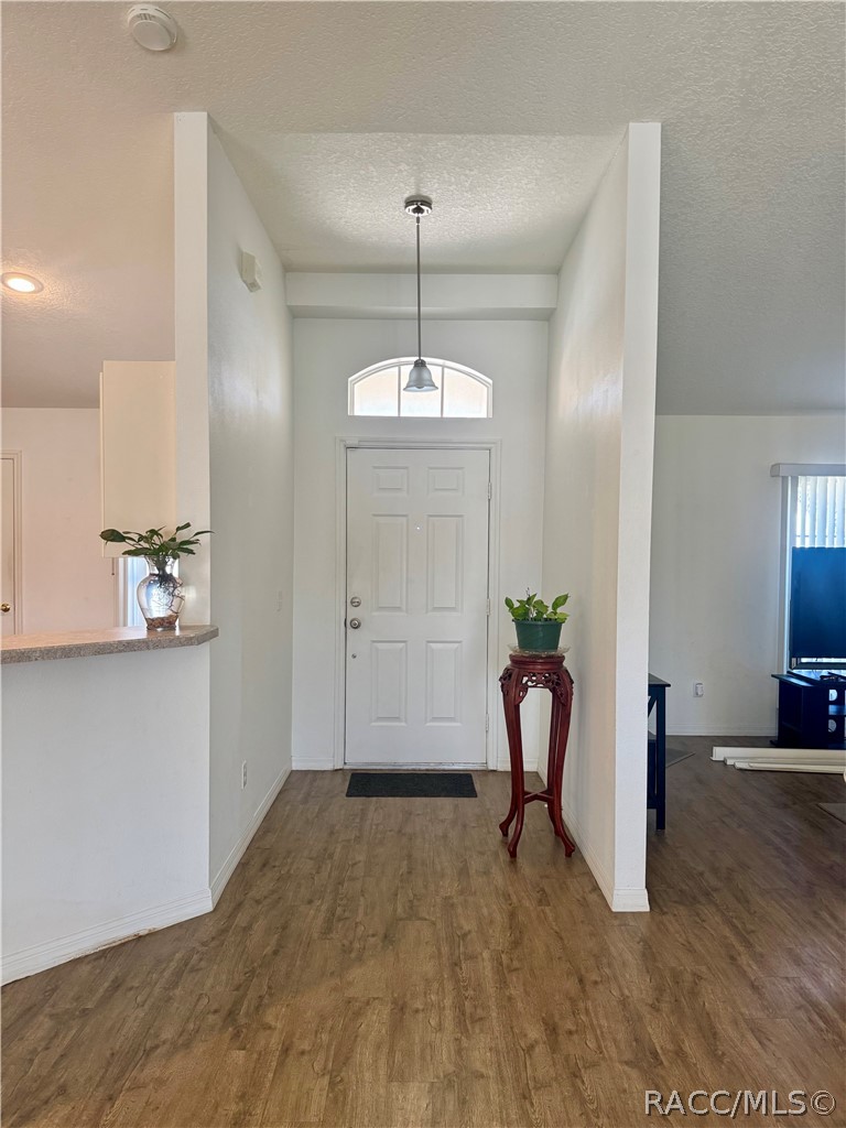 4588 East Van Ness Road Inverness, FL 34453 - Photo 12 of 34 a view of a room with wooden floor and potted plant