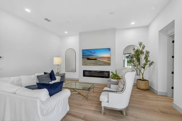 a living room with furniture and a potted plant