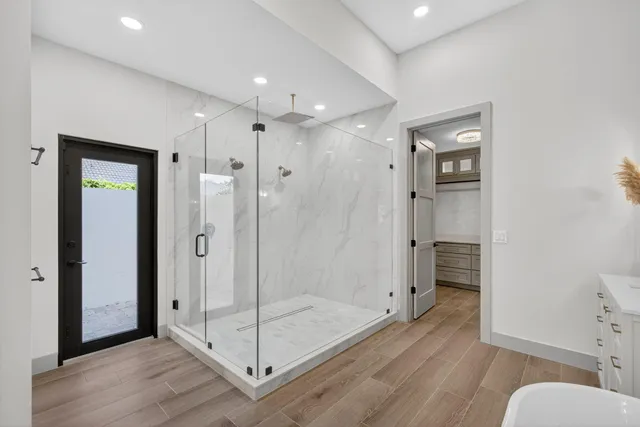 a bathroom with a shower and a glass door