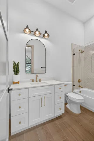 a spacious bathroom with a double vanity sink and a mirror