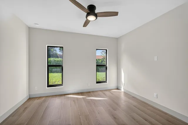 an empty room with windows and closet