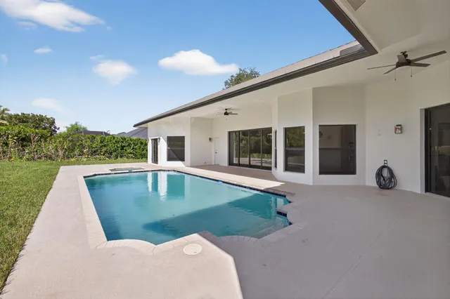 a swimming pool with outdoor seating and yard