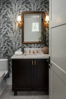 a bathroom with a sink vanity and a mirror