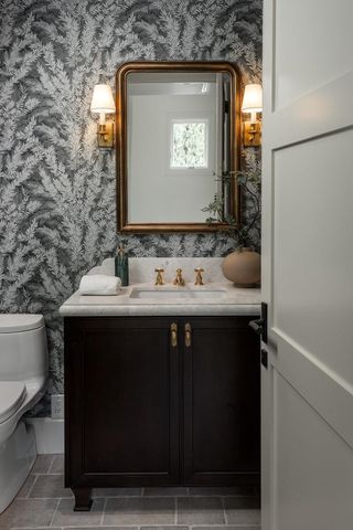 a bathroom with a sink vanity and a mirror