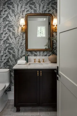 a bathroom with a sink vanity and a mirror