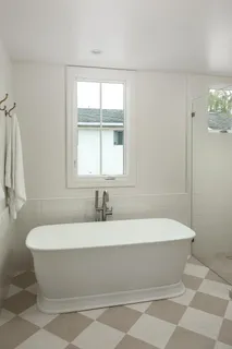 a bathroom with a bathtub and shower