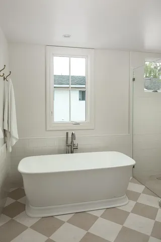 a bathroom with a bathtub and shower