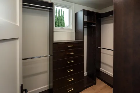 a view of walk in closet with empty racks