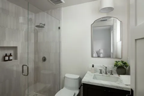 a bathroom with a sink toilet and shower