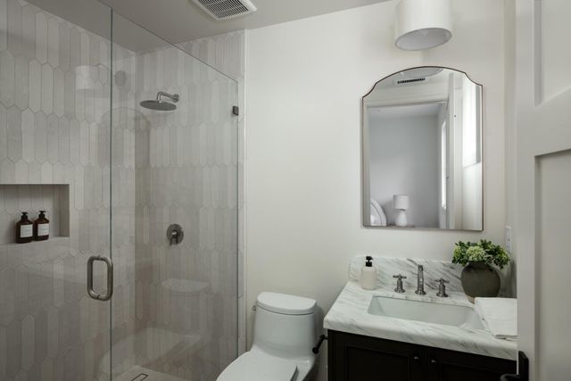 a bathroom with a sink toilet and shower