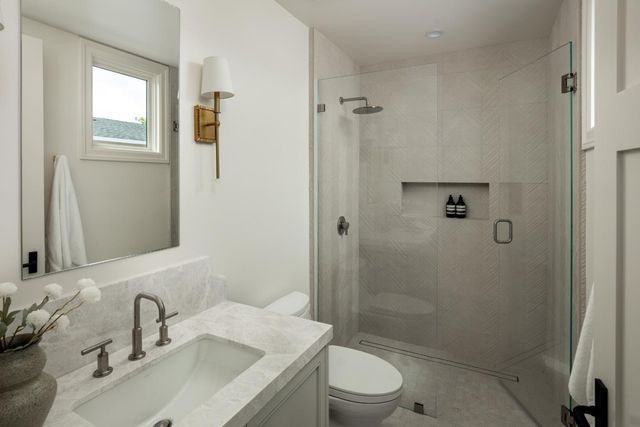 a bathroom with a sink toilet and shower