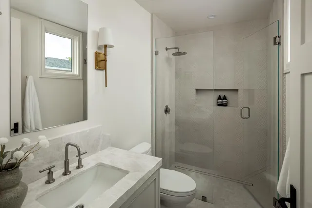 a bathroom with a sink toilet and shower