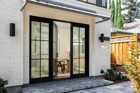 a view of a room that has a table and a chair in it