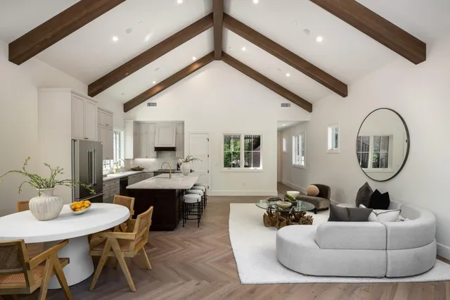 a living room with furniture a rug and white walls
