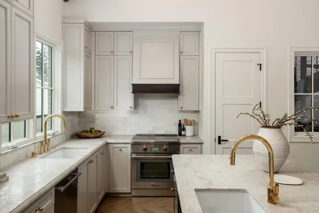 a kitchen with stainless steel appliances granite countertop a sink stove and cabinets