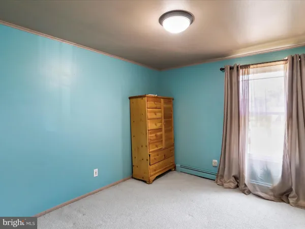 an empty room with closet and mirror