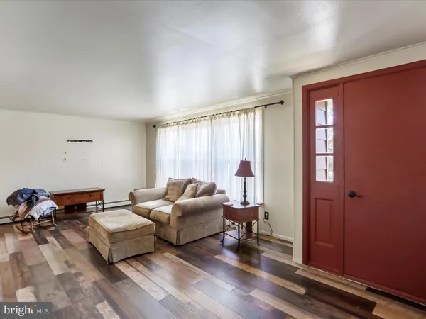a living room with furniture windows and a table
