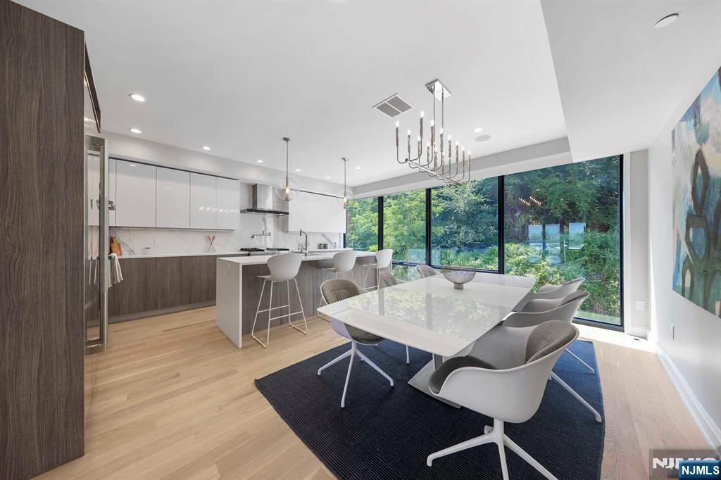8822 Churchill Road North Bergen, NJ 07047 - Photo 38 of 50 a view of a dining room with furniture window and wooden floor