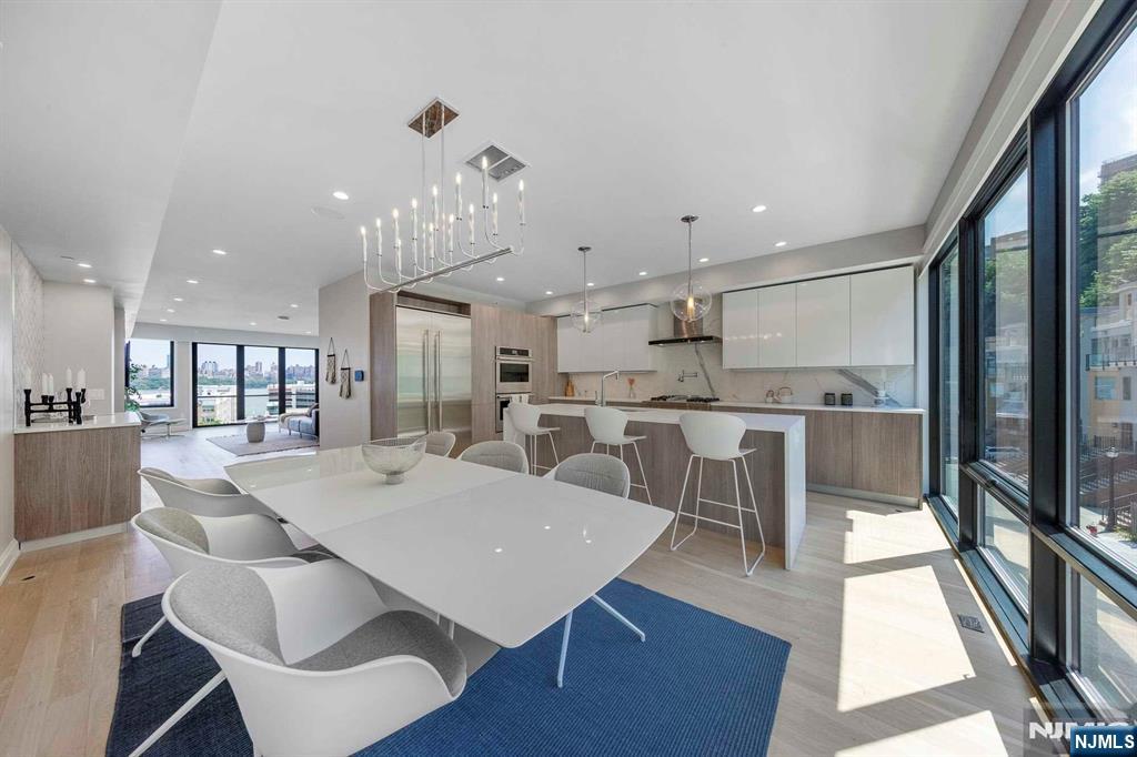 8822 Churchill Road North Bergen, NJ 07047 - Photo 39 of 50 a view of a dining room with furniture a rug and wooden floor