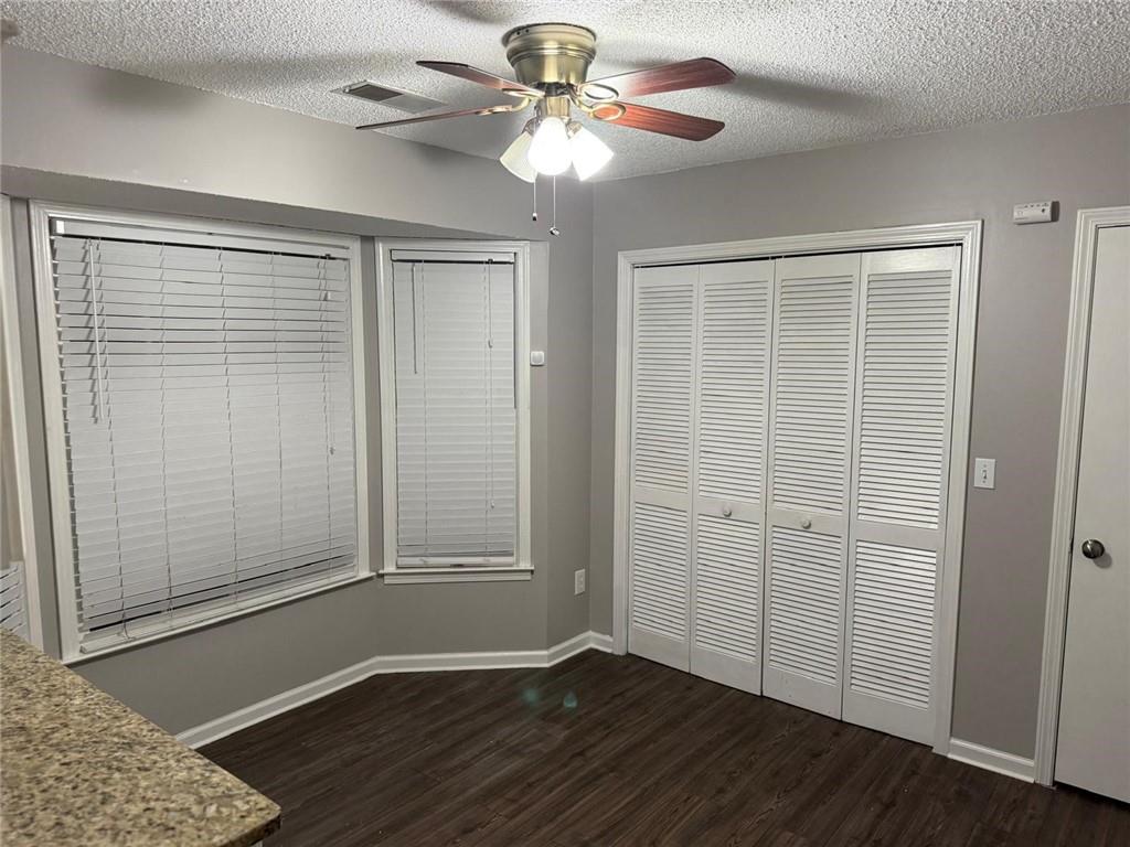 1682 Greyleaf Lane Southeast Dacula, GA 30019 - Photo 11 of 23 an empty room with wooden floor closet and windows