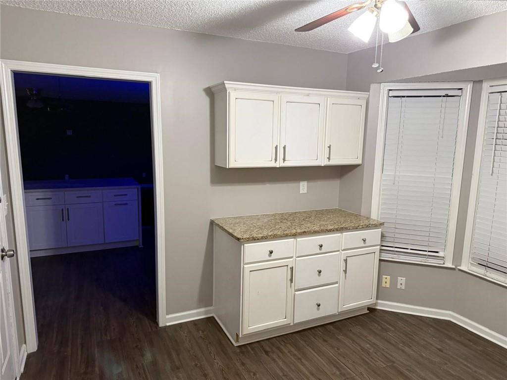 1682 Greyleaf Lane Southeast Dacula, GA 30019 - Photo 12 of 23 a view of cabinets with wooden floor and cabinets