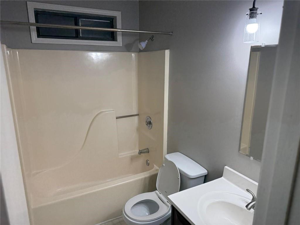 1682 Greyleaf Lane Southeast Dacula, GA 30019 - Photo 14 of 23 a bathroom with a toilet and a bathtub