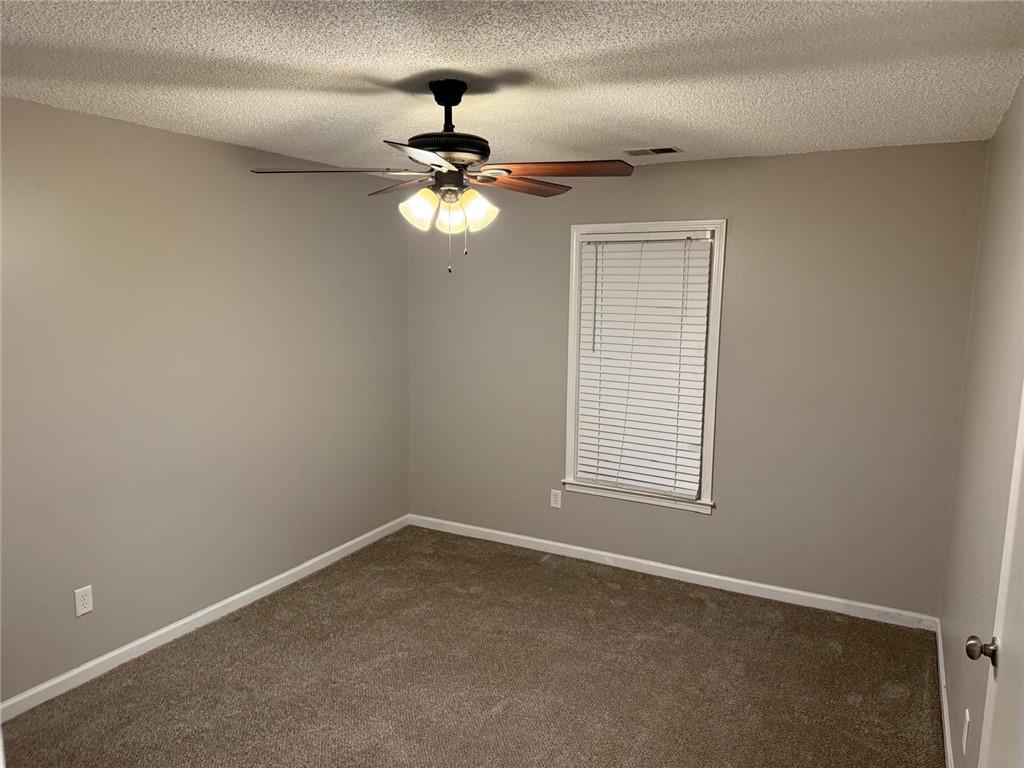 1682 Greyleaf Lane Southeast Dacula, GA 30019 - Photo 18 of 23 a view of a livingroom with a ceiling fan and window