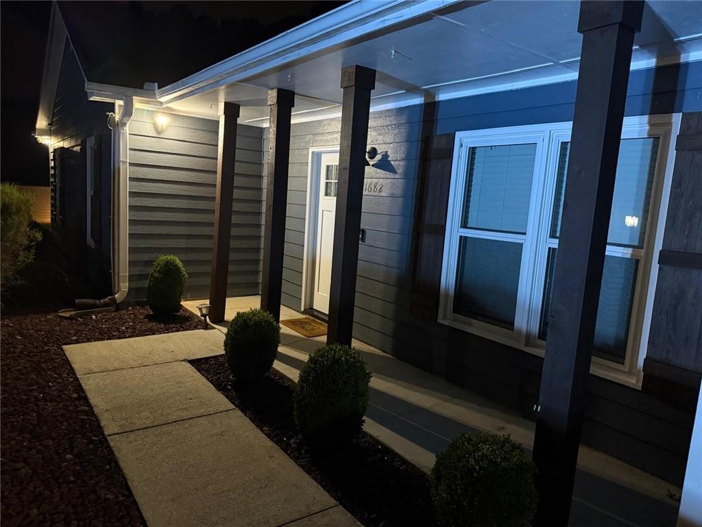 1682 Greyleaf Lane Southeast Dacula, GA 30019 - Photo 2 of 23 a porch with seating space and a balcony
