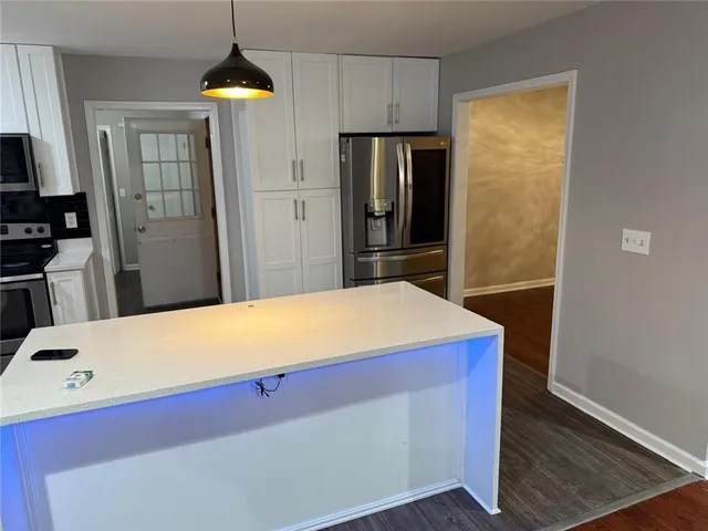 a kitchen with red cabinets