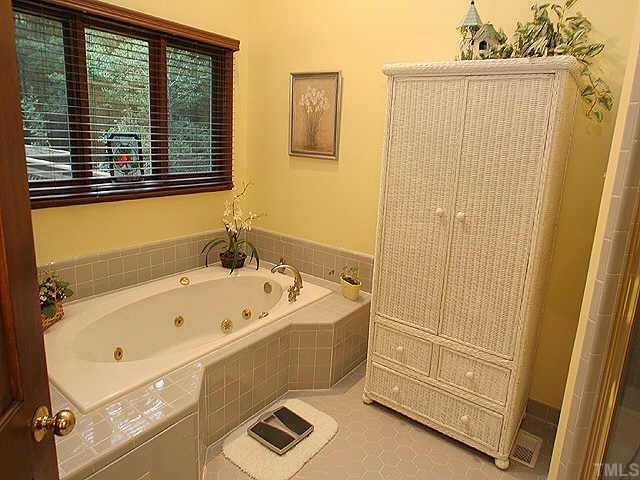 11001 Mason Ridge Drive Raleigh, NC 27614 - Photo 5 of 7 a bathroom with a tub a sink and a window