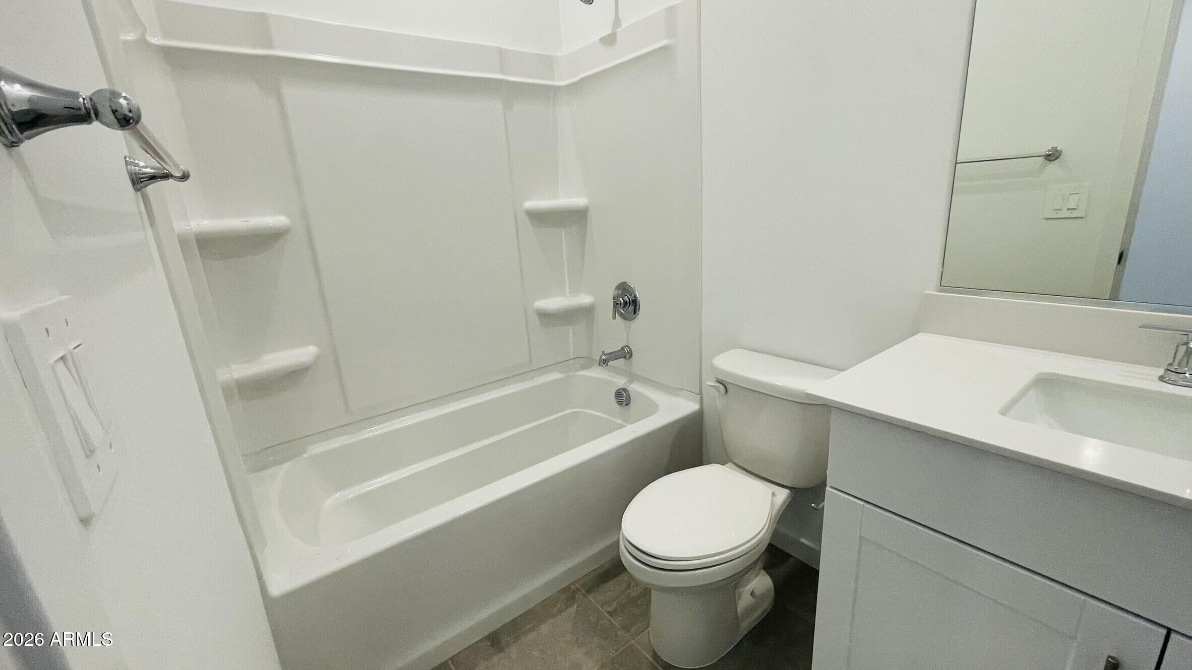 36972 West Prado Street Maricopa, AZ 85138 - Photo 11 of 17 a bathroom with a toilet a sink and bathtub