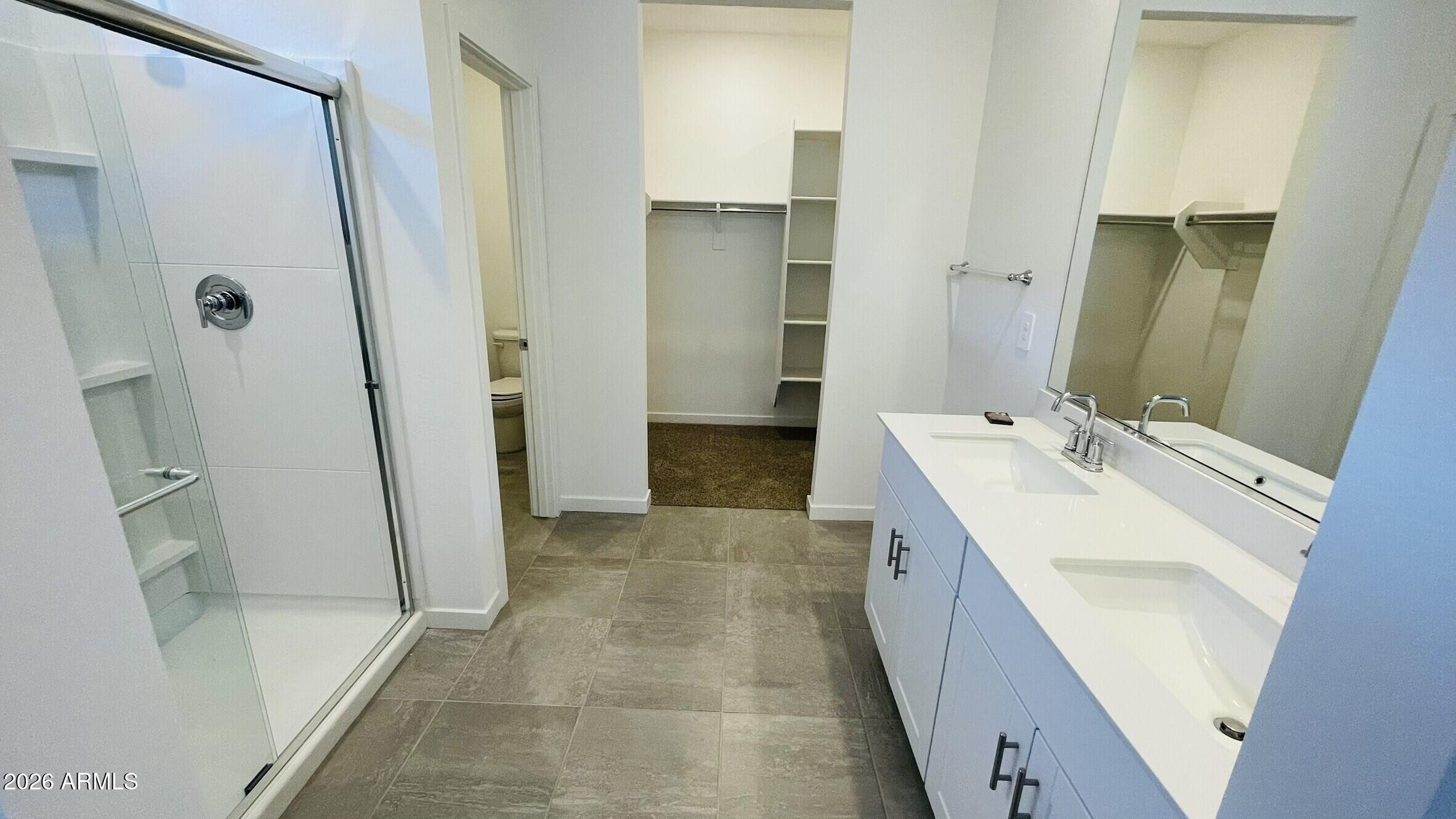 36972 West Prado Street Maricopa, AZ 85138 - Photo 15 of 17 a bathroom with a double vanity sink and mirror