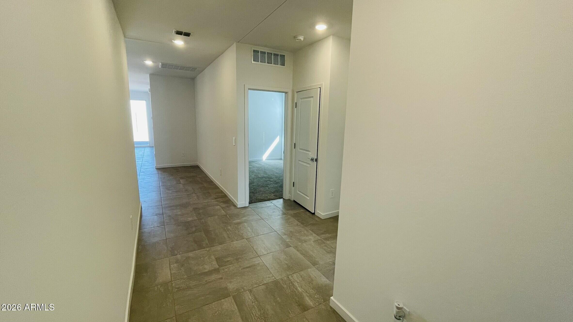 36972 West Prado Street Maricopa, AZ 85138 - Photo 2 of 17 an empty room with an entrance to other room