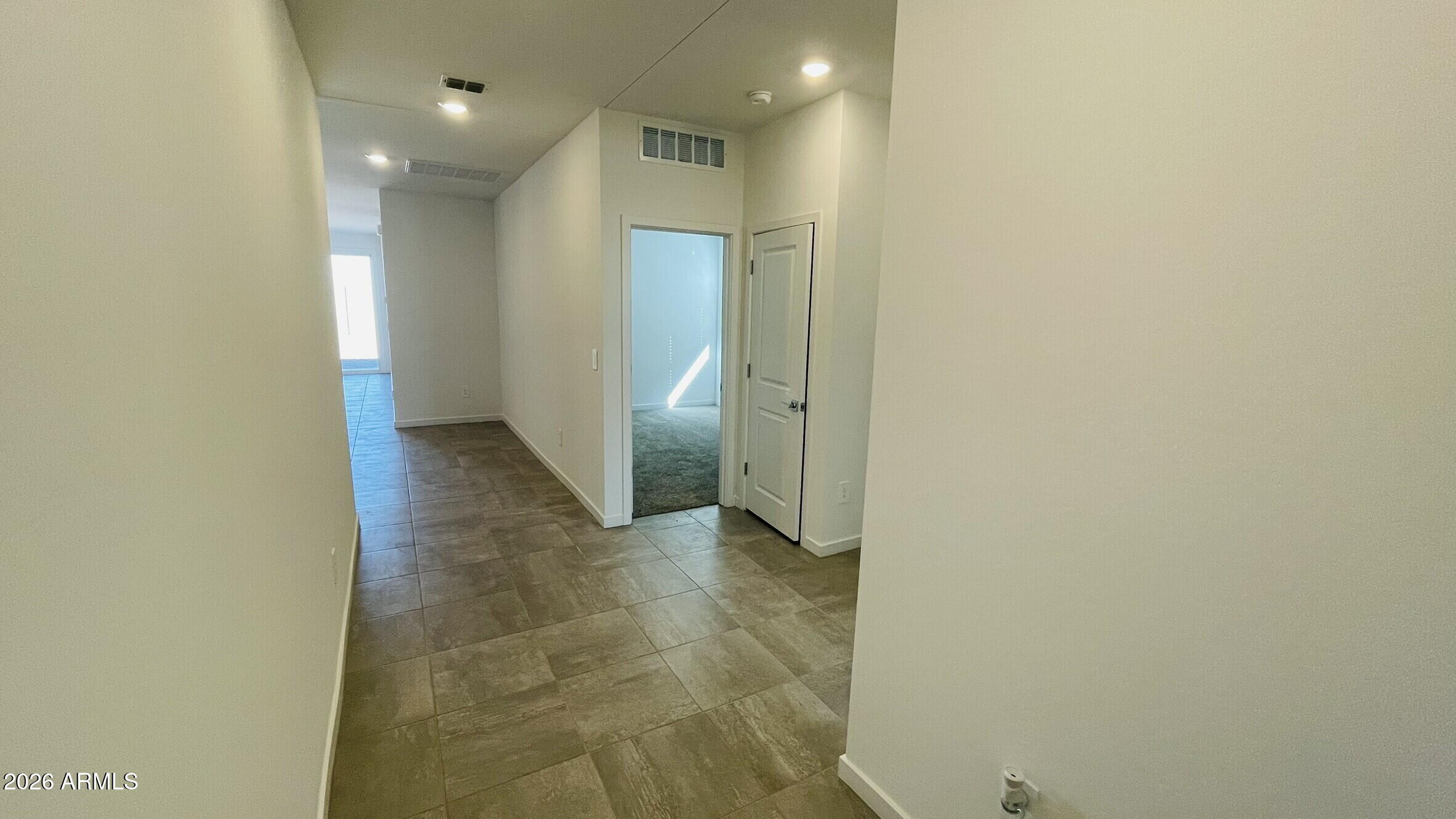 36972 West Prado Street Maricopa, AZ 85138 - Photo 2 of 18 an empty room with an entrance to other room