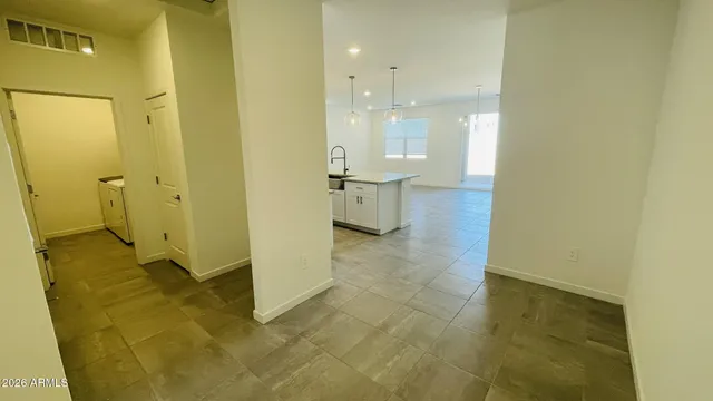 an empty room with an entrance to other room