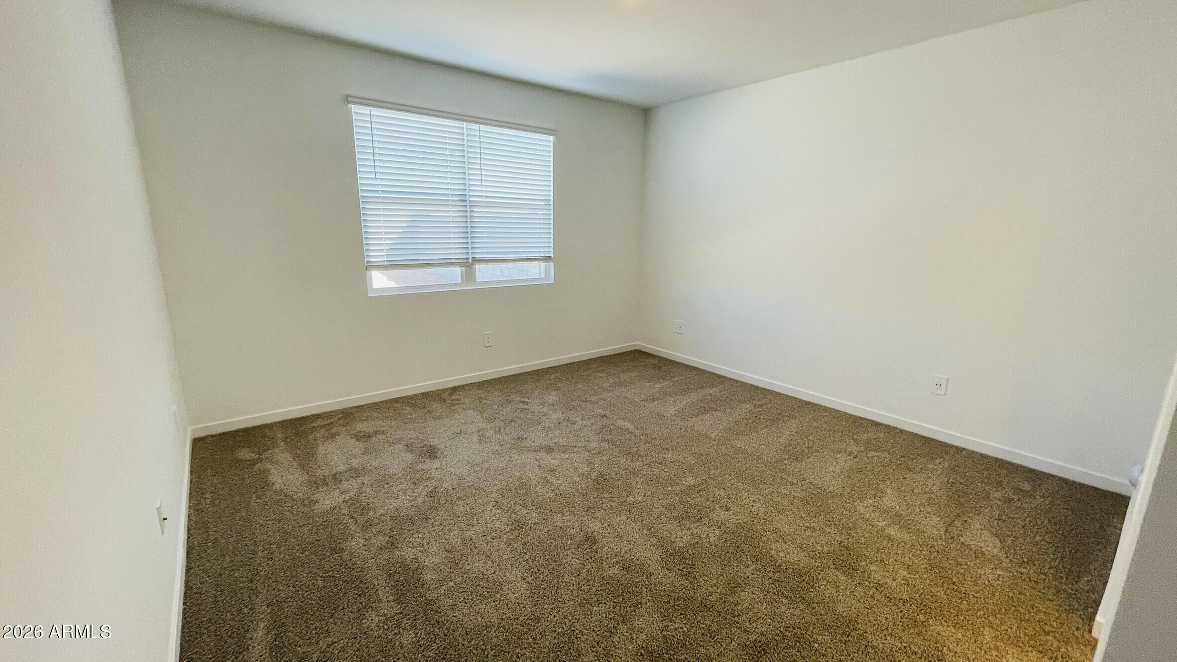 36972 West Prado Street Maricopa, AZ 85138 - Photo 6 of 17 an empty room with a window