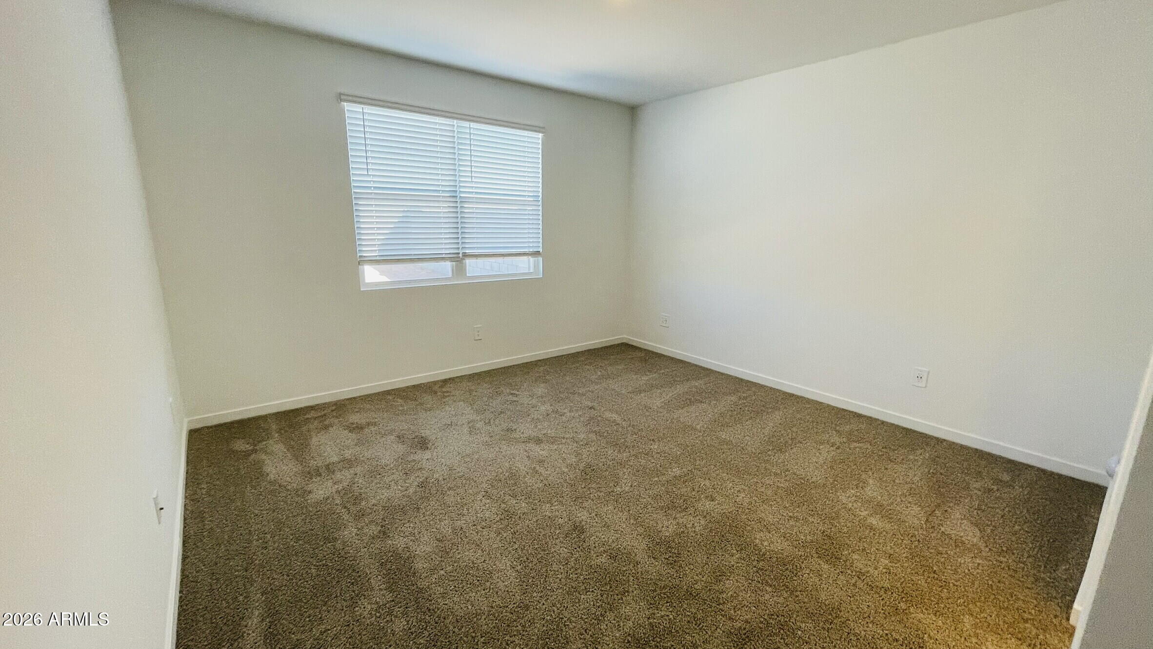 36972 West Prado Street Maricopa, AZ 85138 - Photo 6 of 18 an empty room with a window