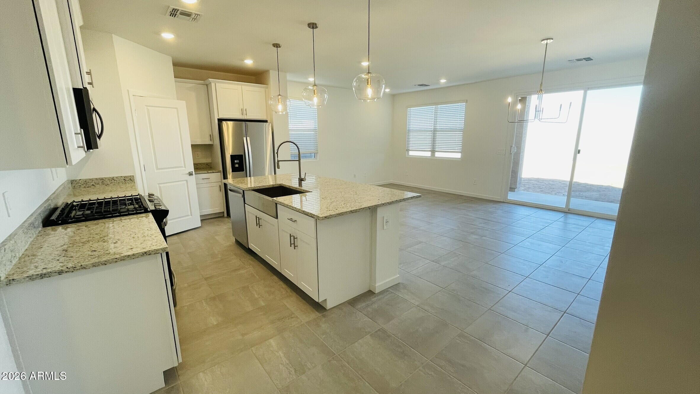 36972 West Prado Street Maricopa, AZ 85138 - Photo 7 of 18 a kitchen with a sink a stove a refrigerator and window