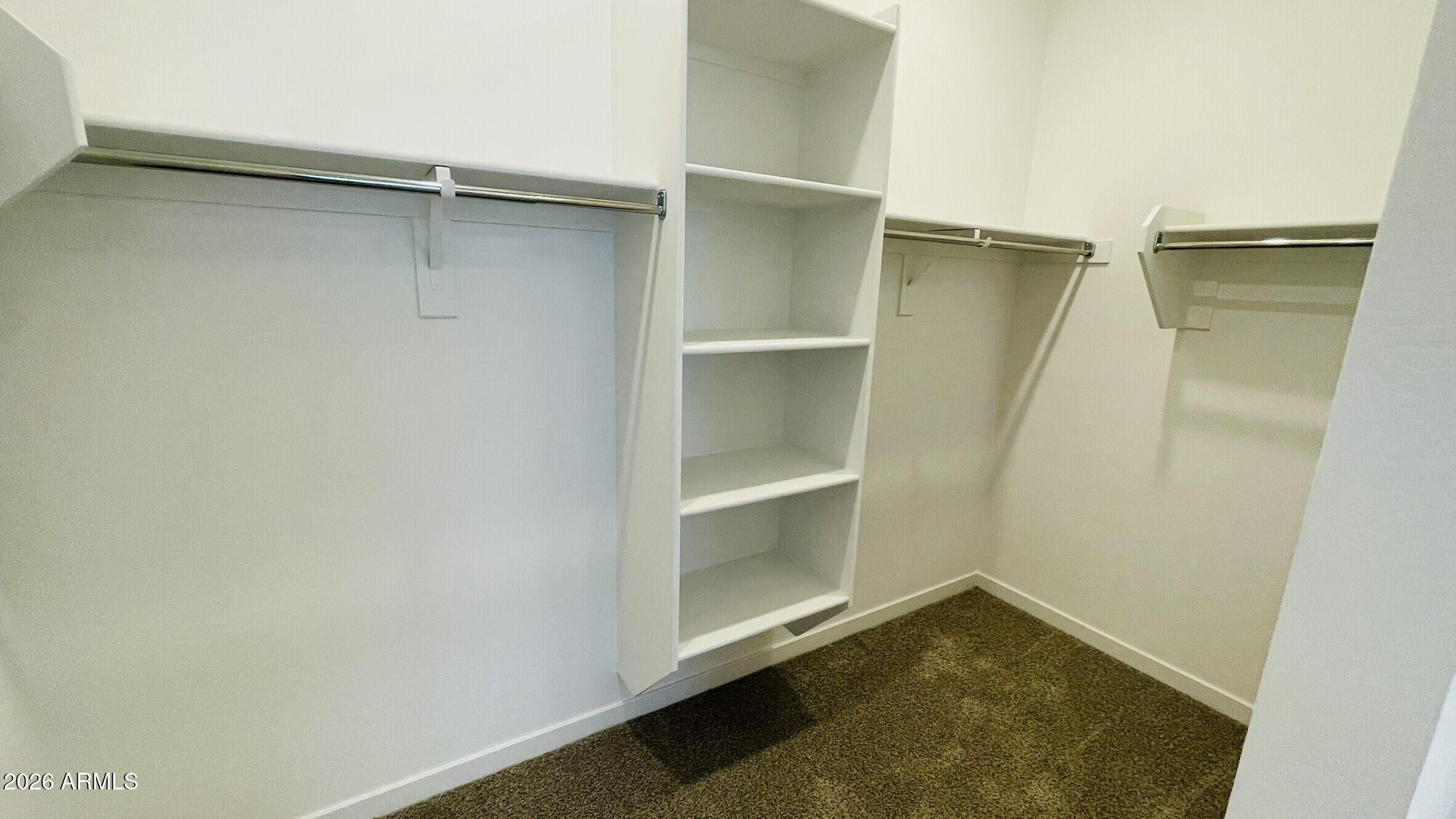 36972 West Prado Street Maricopa, AZ 85138 - Photo 10 of 17 a view of walk in closet with empty racks