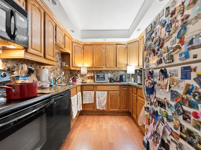 a kitchen with stainless steel appliances a sink and a stove