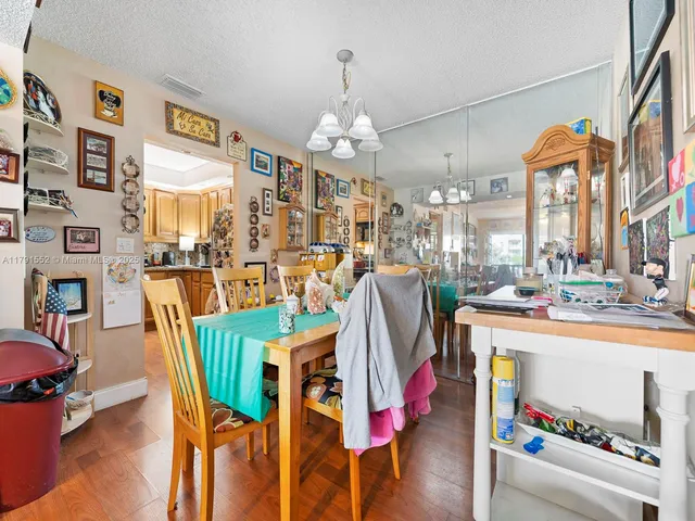 a dining room filled with furniture and a chandelier