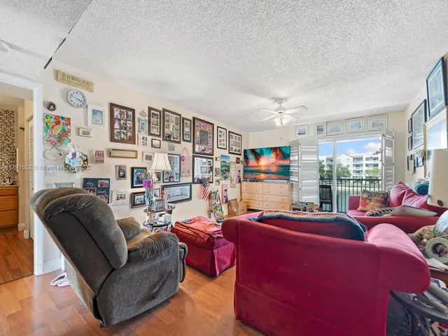 a living room with furniture a fireplace and a large window