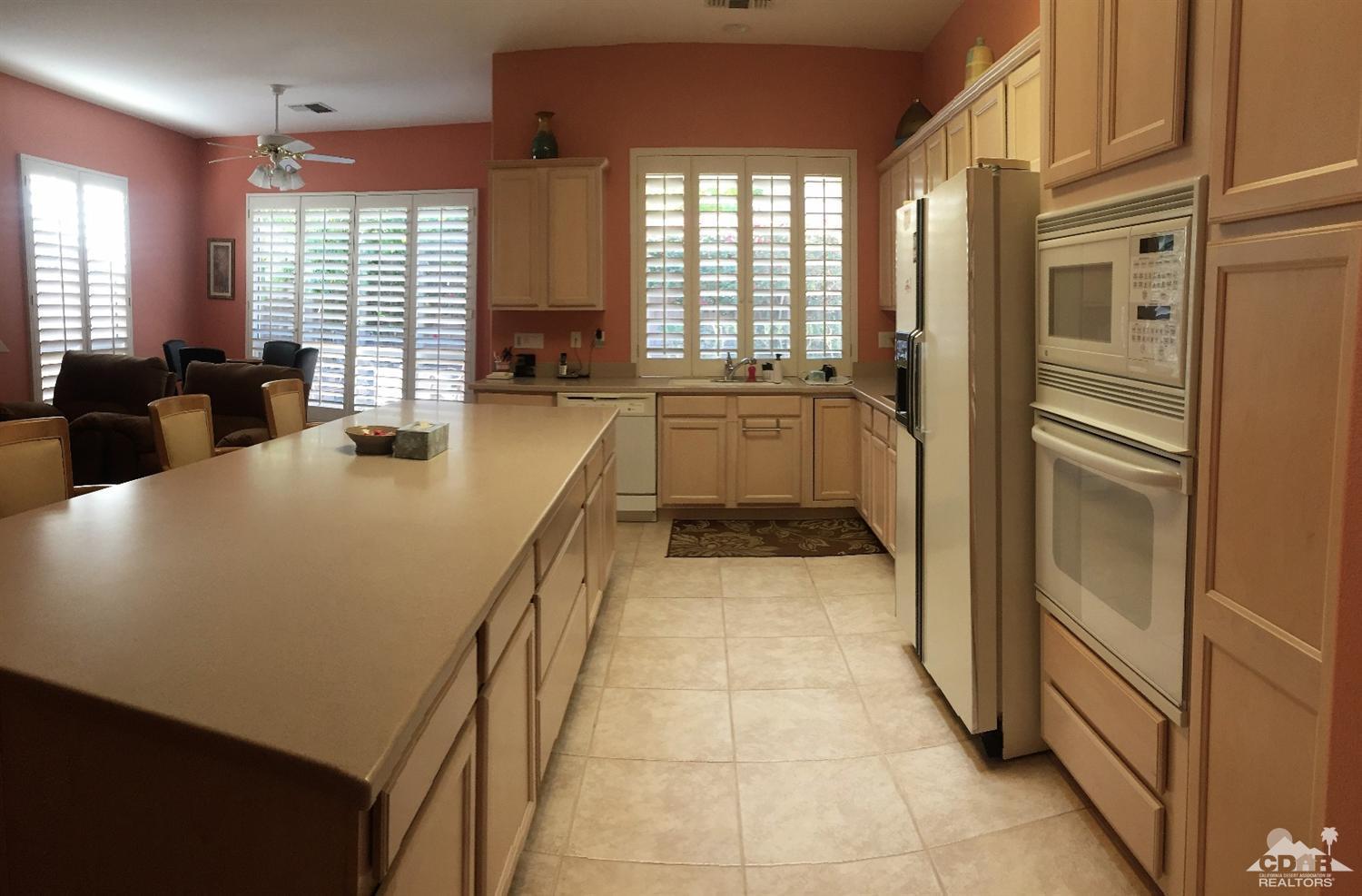 37235 Skycrest Road Palm Desert, CA 92211 - Photo 14 of 34 a large white kitchen with a large window