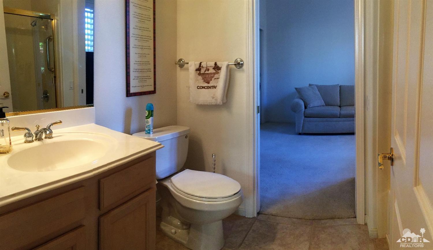 37235 Skycrest Road Palm Desert, CA 92211 - Photo 17 of 34 a bathroom with a granite countertop toilet sink and mirror