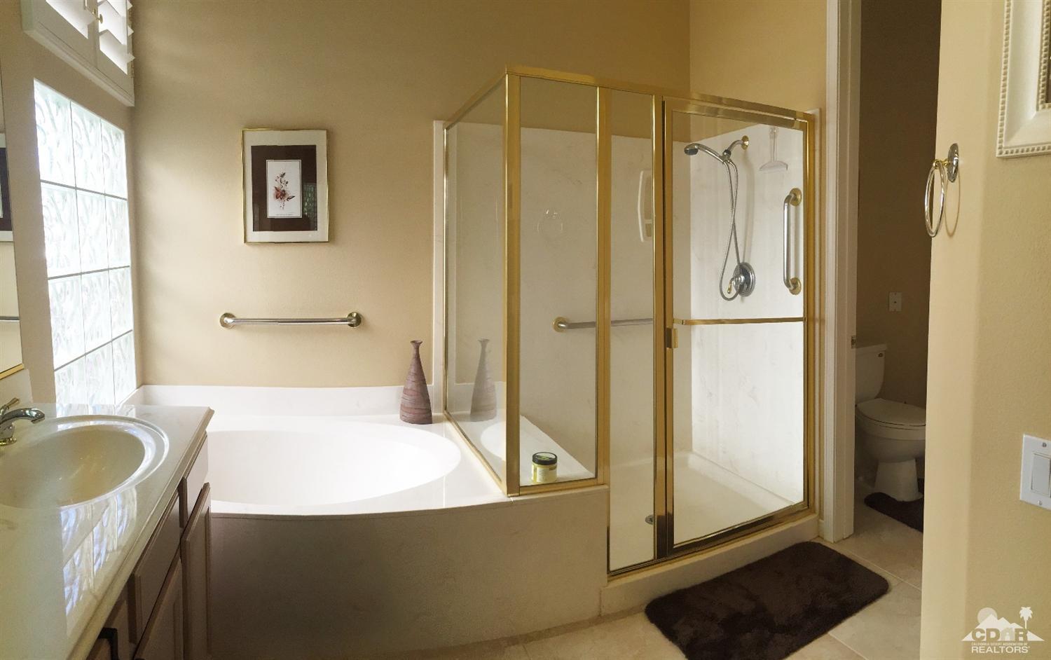 37235 Skycrest Road Palm Desert, CA 92211 - Photo 21 of 34 a bathroom with a tub a sink and a shower
