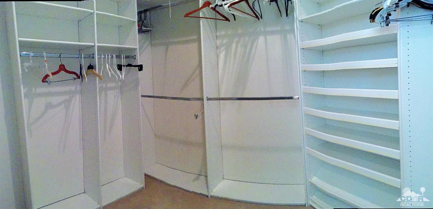 37235 Skycrest Road Palm Desert, CA 92211 - Photo 22 of 34 a view of walk in closet with clothes and shoes