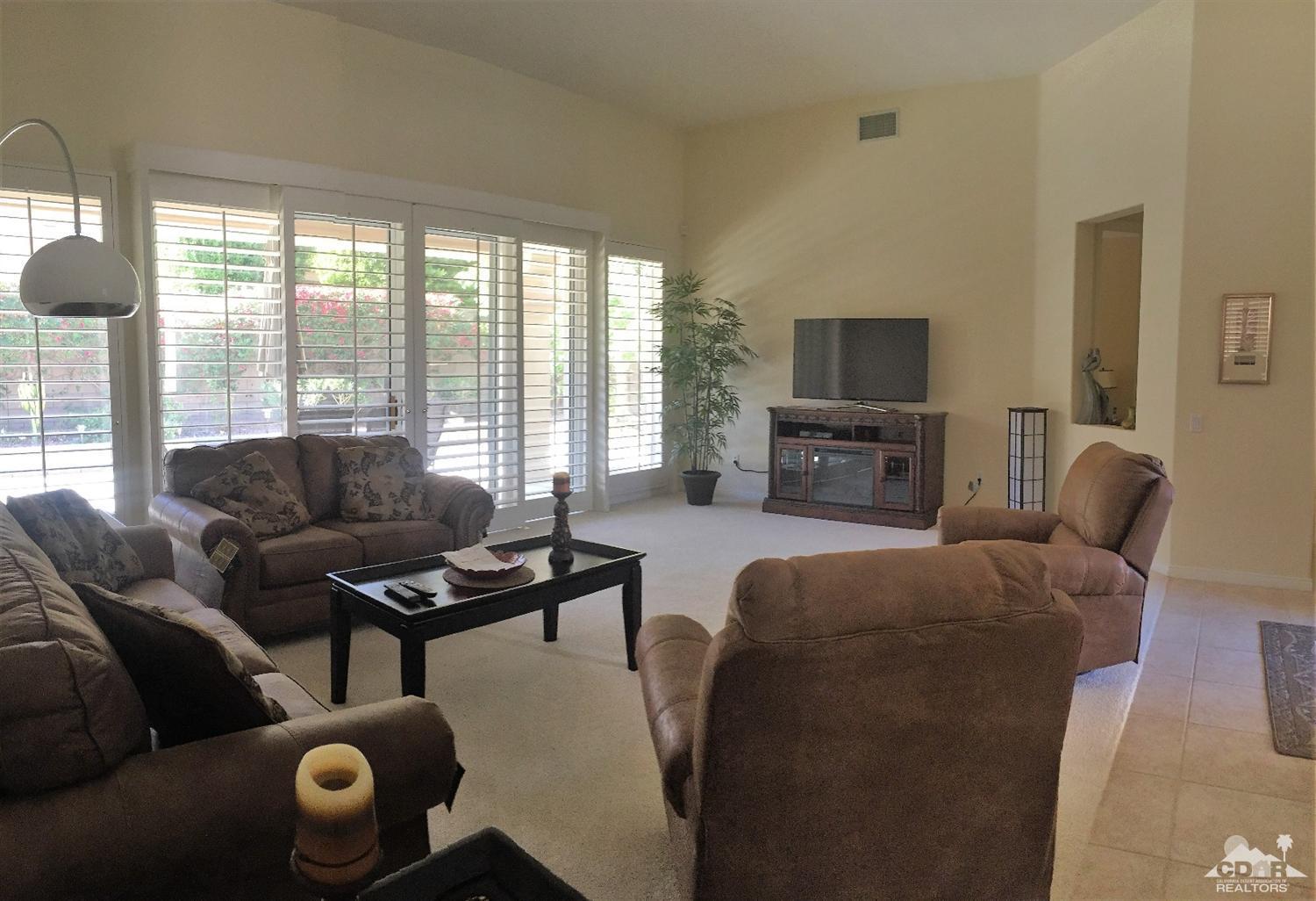 37235 Skycrest Road Palm Desert, CA 92211 - Photo 9 of 34 a living room with furniture and a flat screen tv