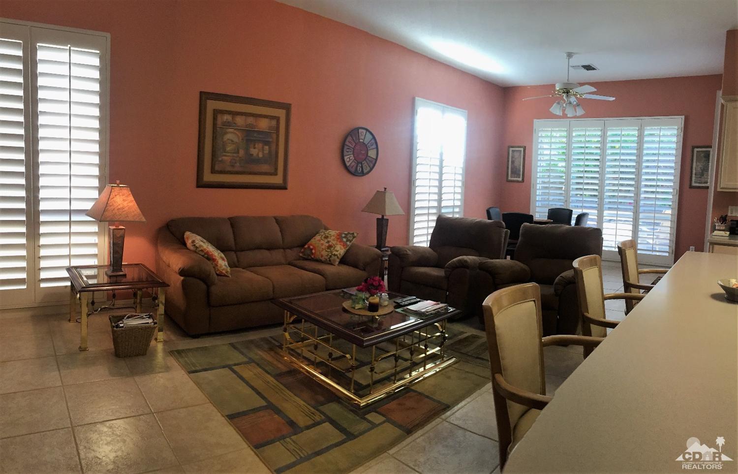 37235 Skycrest Road Palm Desert, CA 92211 - Photo 10 of 34 a living room with furniture a large window and a dining table